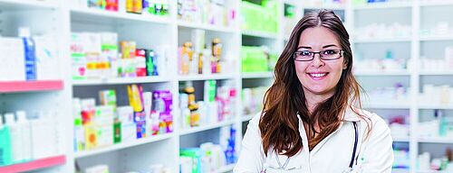 Pharmacist chemist woman standing in pharmacy - drugstore